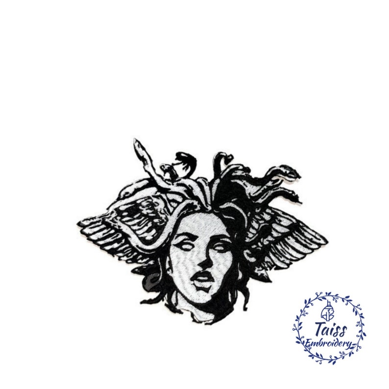 May include: Black and white embroidered patch of Medusa's head with snakes for hair and wings. The patch is on a white background.