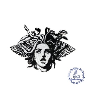 May include: Black and white embroidered patch of Medusa, a mythical Greek figure with snakes for hair and wings. The patch features a detailed design of Medusa's face and hair.