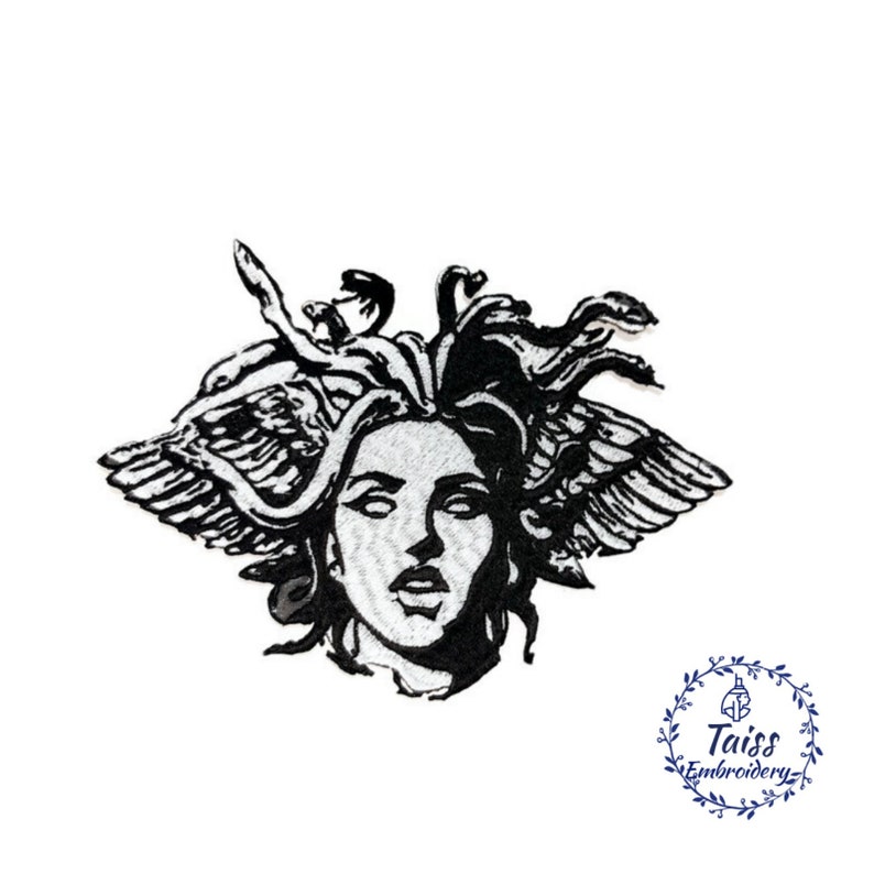 May include: Black and white embroidered patch of Medusa, a mythical Greek figure with snakes for hair and wings. The patch features a detailed design of Medusa's face and hair.