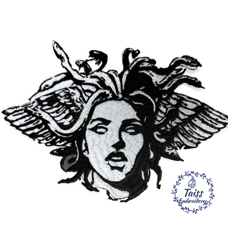 May include: Black and white embroidered patch of Medusa, a mythical Greek figure with snakes for hair, wings, and a human face. The patch is on a white background.