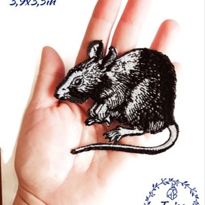 May include: Black and white embroidered iron-on patch of a rat, measuring 10cm by 9cm. The patch is shown on a hand for size comparison. The patch is from Taiss Embroidery.