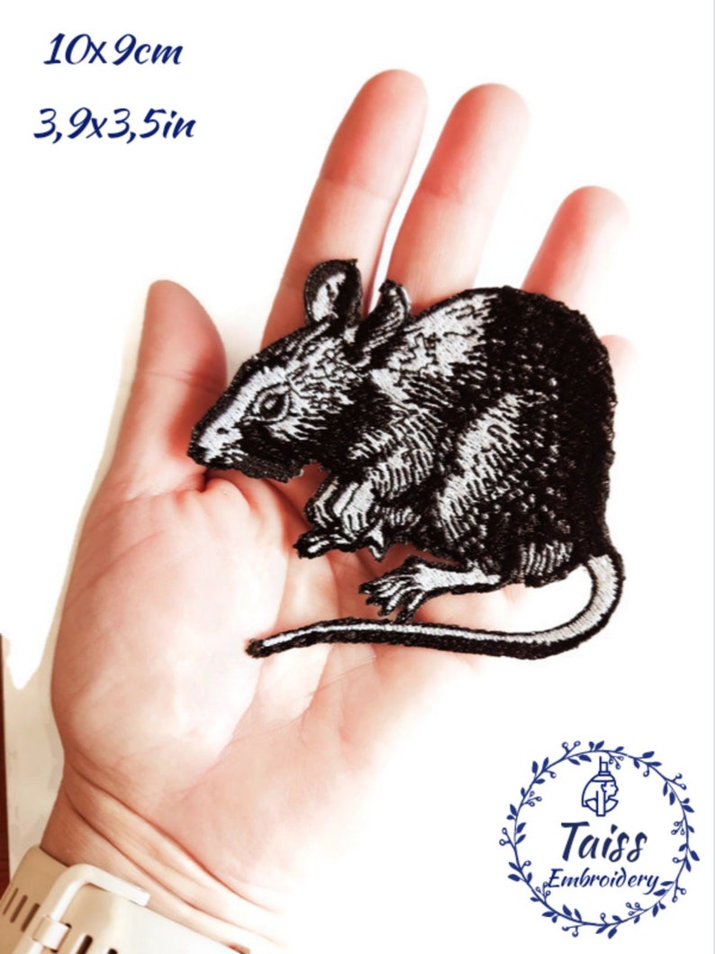 May include: Black and white embroidered iron-on patch of a rat, measuring 10cm by 9cm. The patch is shown on a hand for size comparison. The patch is from Taiss Embroidery.