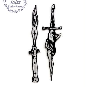 May include: Two black and white embroidered iron-on patches of swords. The swords are stylized and have a skeletal appearance.