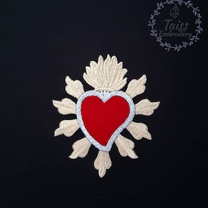 May include: A red embroidered heart with a gold and silver halo. The heart is surrounded by a decorative floral design. The image includes the text "Taiss Embroidery".