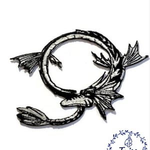 May include: Black and white embroidered iron-on patch of a dragon curled in a circle. The dragon has detailed scales and wings.