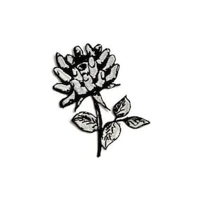 May include: Black and white embroidered patch of a rose with an eye in the centre of the flower. The rose has a stem and leaves.