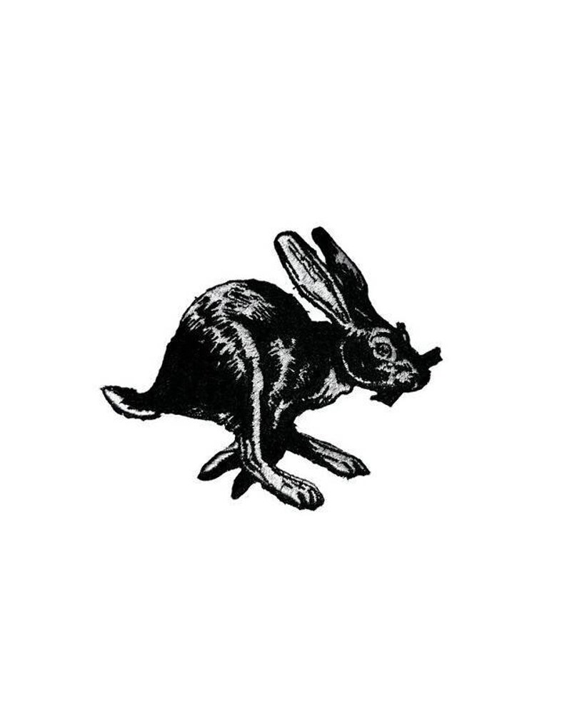 May include: Black and white illustration of a rabbit running. The rabbit is depicted in a stylized, almost cartoonish manner, with large ears and a long tail.