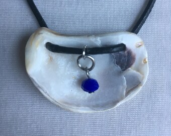Unique oyster shell with blue charm