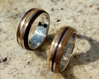 Pair of wedding rings in green ebony wood and oak on silver ring