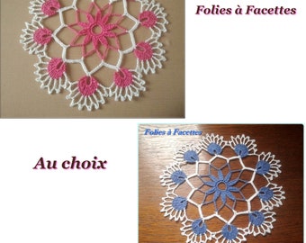 Round lace doily with white and blue crochet flowers