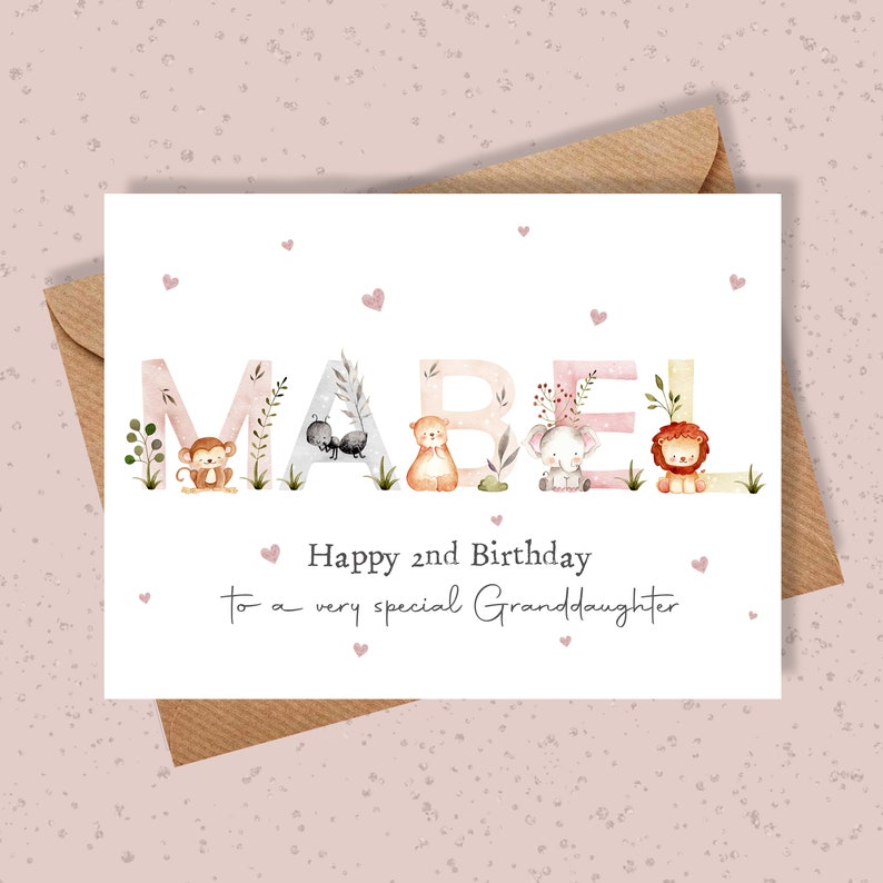 May include: A birthday card with the name Mabel spelled out in large letters with animals in each letter. The card says "Happy 2nd Birthday to a very special Granddaughter".
