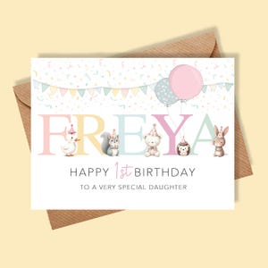 May include: A pastel-coloured birthday card for a daughter, featuring the name "FREYA" and illustrations of animals in party hats. The card includes the text "HAPPY 1st BIRTHDAY TO A VERY SPECIAL DAUGHTER" and two balloons.