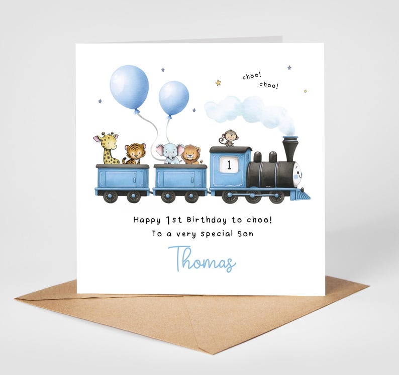 May include: A birthday card featuring a blue train with animal passengers, including a giraffe, tiger, elephant, lion, and monkey. Two blue balloons float above the train. The card reads "Happy 1st Birthday to choo! To a very special son Thomas."