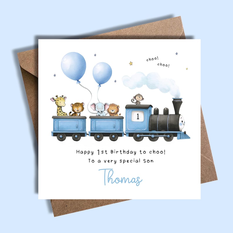 May include: A birthday card featuring a blue train with animal passengers and two blue balloons. The card reads "Happy 1st Birthday to choo! To a very special Son Thomas."