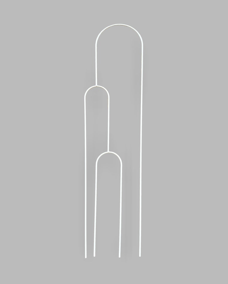May include: White metal plant support with three hoops. The support is designed to help plants grow upright.