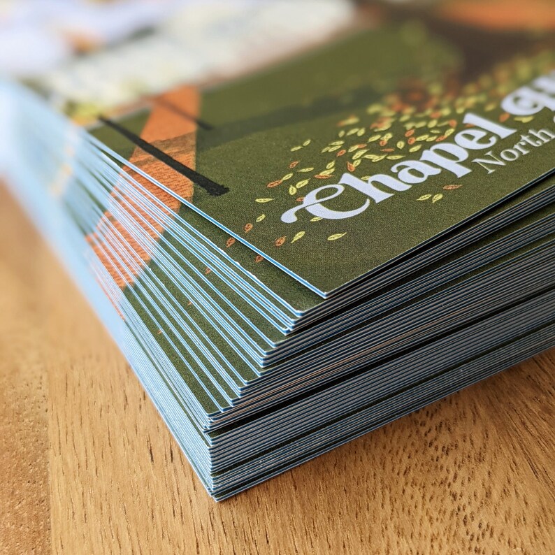 A detail shot of the postcards shows the quality of the cardstock and the blue core around the edge of the postcard