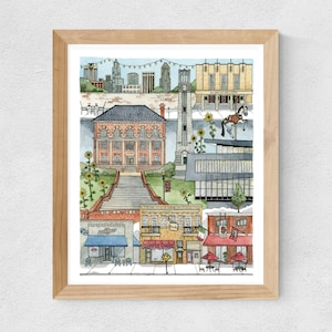May include: A watercolor illustration of a city scene with buildings, a carousel, and a coffee shop. The illustration is framed in a light wood frame.