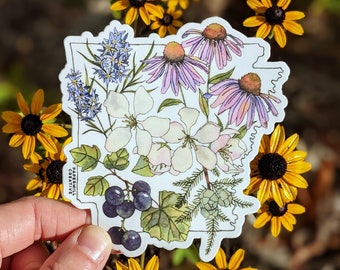 May include: A white sticker with a watercolor illustration of various flowers and plants, including purple coneflowers, white apple blossoms, blue flowers, and green leaves. The sticker has a white border and the text "Papermill Creative" in black lettering.