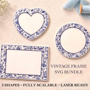 May include: A collection of three white ceramic shapes: a heart, a circle, and a rectangle. Each piece features a blue floral border and a blank white center. The text "VINTAGE FRAME SVG BUNDLE" is visible, along with "3 SHAPES • FULLY SCALABLE • LASER READY".