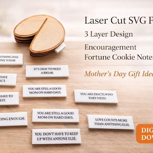 May include: A wooden fortune cookie with several white rectangular notes with black text. The notes contain encouraging phrases. The image also includes the text "Laser Cut SVG File," "3 Layer Design," and "Mother's Day Gift Idea."