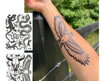May include: A temporary tattoo sheet featuring black ink illustrations of a snake, lizard, scorpion, spider, and centipede, alongside a second sheet showing a bull skull, eagle, and insects, with an eagle tattoo applied to a forearm.
