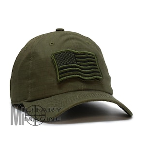 May include: Olive green baseball cap with a patch featuring an American flag. The cap has a curved brim and a structured crown. The flag patch is in shades of green. The cap is made of a durable, textured fabric.
