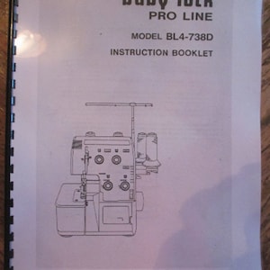 May include: Black and white line drawing of a Baby Lock Pro Line BL4-738D sewing machine. The instruction booklet cover features the model name and the words "Instruction Booklet".