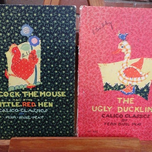 May include: Two vintage children's books with colorful illustrations. The book on the left is titled "The Cock The Mouse and the Little Red Hen" and the book on the right is titled "The Ugly Duckling". Both books are part of the "Calico Classics" series by Fern Bisel Peat.