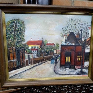 May include: A white ceramic mug with a black handle and the text "But First, Coffee" in a bold, black font. The mug is set against a blurred background, suggesting a cozy setting.