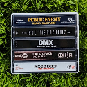 May include: A collection of five cassette tapes, each with album titles and artist names. The tapes showcase "Public Enemy: Fear of a Black Planet," "Big L: The Big Picture," "DMX: ...And Then There Was X," "Eric B. & Rakim: Paid in Full," and "Mobb Deep: The Infamous."
