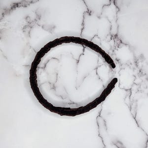 chocolate brown velvet padded headband photographed on its side