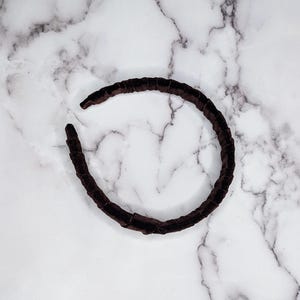 chocolate brown velvet padded headband photographed on its side