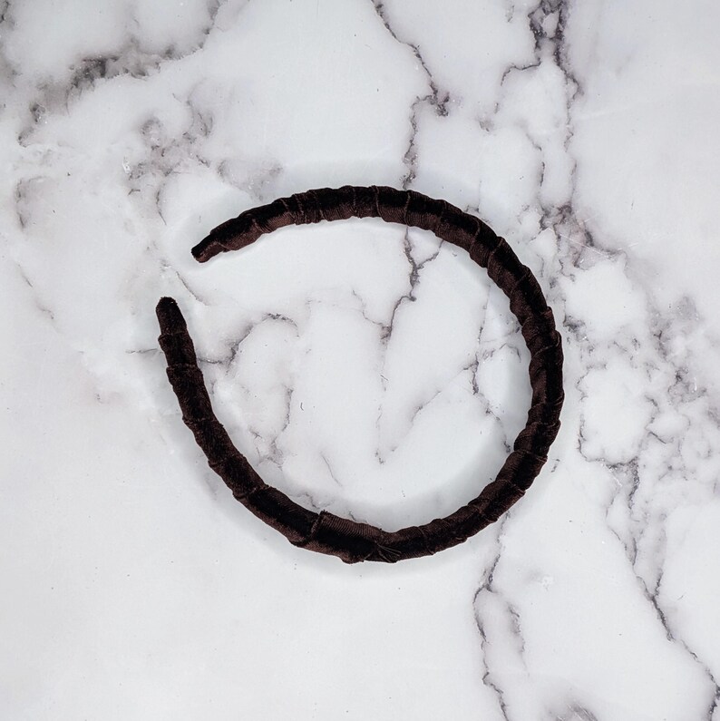 chocolate brown velvet padded headband photographed on its side