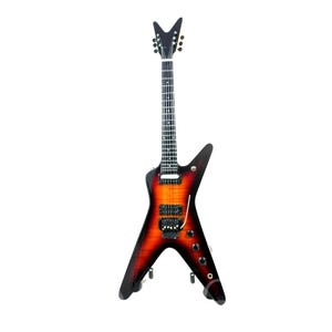 May include: An electric guitar with a distinctive V-shaped body featuring a sunburst finish that transitions from a bright orange center to deep black edges. It has a black headstock, a dark fretboard with dot inlays, two humbucker pickups, and black hardware.
