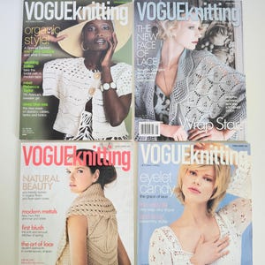 May include: Four issues of Vogue Knitting magazine arranged in a grid. Each cover features a model wearing a different knitted garment, including white and grey lace-patterned tops. The covers display various text headlines and issue dates.