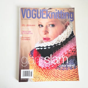 May include: Vogue Knitting International magazine issue 200 featuring a cover model wearing a chunky knit cowl in white, black, pink, red, and orange. The cover text includes Kilty Pleasures, Chic Frills, Pillow Talk, By Invitation Only, Nouveau Novelties, and Glam Slam Color Wins.