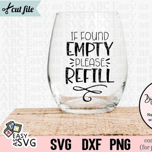 Puede incluir: Una copa de vino transparente con el texto "IF FOUND EMPTY PLEASE REFILL" en negro. La imagen también incluye las palabras "Digital Download ONLY" y "SVG DXF PNG". La copa está sobre una superficie de madera.