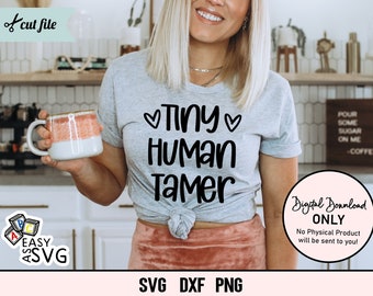 May include: A gray t-shirt with the text "Tiny Human Tamer" in black lettering and a heart on either side of the word "Tiny".