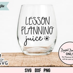 May include: A clear wine glass with the text "LESSON PLANNING juice" in black lettering. The text is written in a handwritten style. A small heart is next to the word "juice".