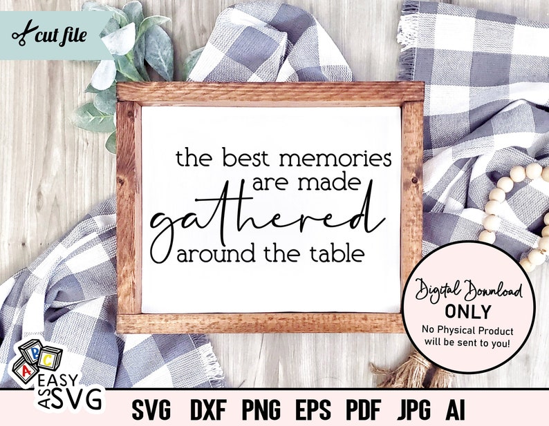 May include: A wooden sign with the text "The best memories are made gathered around the table". The sign is sitting on a white and gray checkered fabric.