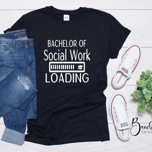 May include: Black t-shirt with white text that reads "Bachelor of Social Work Loading" with a progress bar and graduation cap icon.