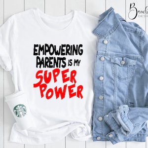 May include: White t-shirt with black text that reads "Empowering Parents is my Super Power" in red.
