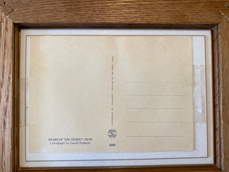 May include: A vintage postcard featuring a lithograph of "Arabs of the Desert" by David Roberts. The postcard is printed in the Holy Land and has a copyright date of 1839.