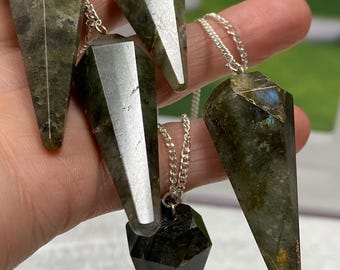 May include: Four silver chain pendulums with green and black labradorite crystal points. The pendulums are of varying sizes.
