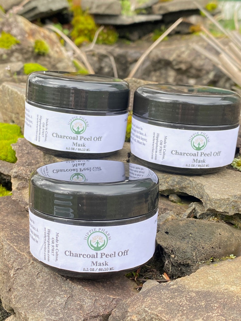 May include: Three black jars of charcoal peel off mask with white labels. The labels have the text "Hippie Pharm" and "Charcoal Peel Off Mask" with the size "2.1 oz / 62.10 ml".