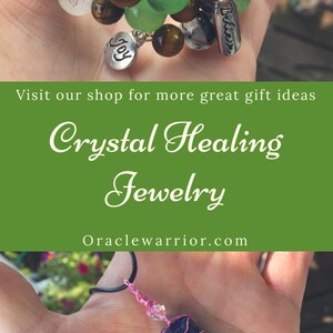 May include: Two crystal bracelets with green, brown, and white beads. The bracelets have charms that say "Believe" and "Joy". A necklace with a blue crystal pendant wrapped in pink wire.