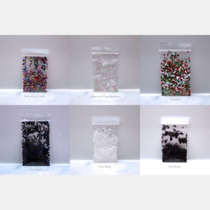 May include: Six small bags of glitter, each with a different color or pattern. The bags are labeled with the following names: Holo Mixed Color, Iridescent Clear Rainbow, Christmas, Holo Black, Pure White, and Pure Black.
