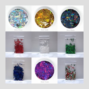 May include: Assortment of holographic glitter in various colors, including silver, gold, black, red, green, blue, violet, and white. The glitter is packaged in small plastic bags and clear containers.
