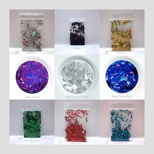 May include: Nine small bags of holographic glitter in various colors, including silver, black, gold, violet, crystal, deep blue, emerald green, rally red, and sapphire blue. Each bag contains a different color of glitter shaped like bats.
