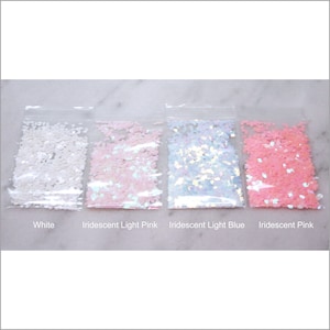 May include: Four small bags of iridescent glitter in white, light pink, light blue, and pink. The bags are labeled with the color of the glitter.